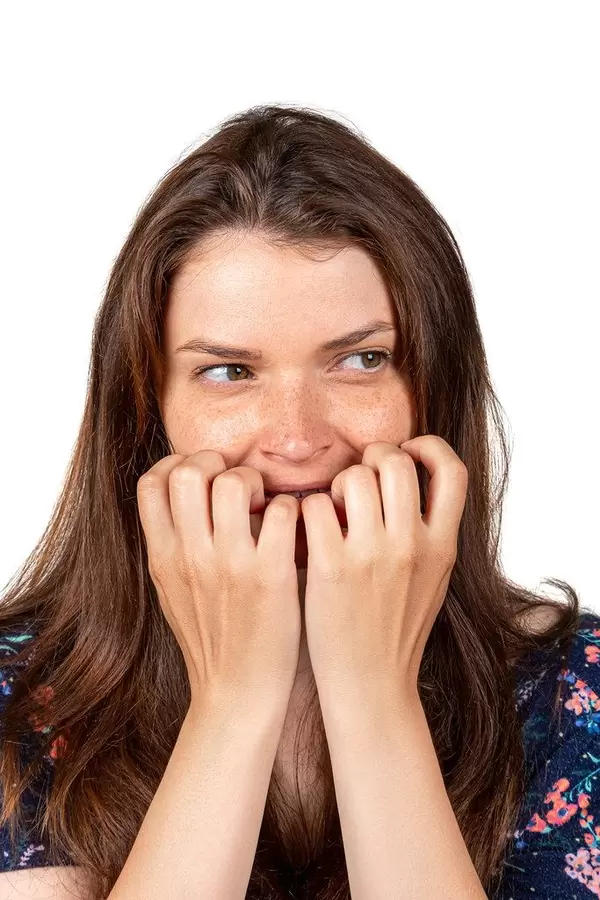 Concept of anxiety, portrait of a girl with hands near her face