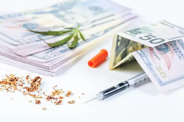 Concept of illegal business and drug problem - syringe, money and cannabis