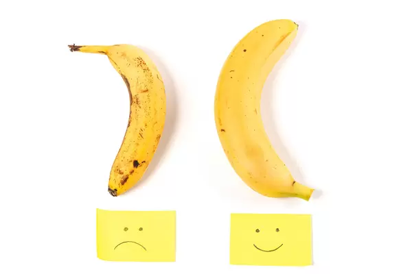 Concept of potency, smiley and sad faces with two bananas up and down