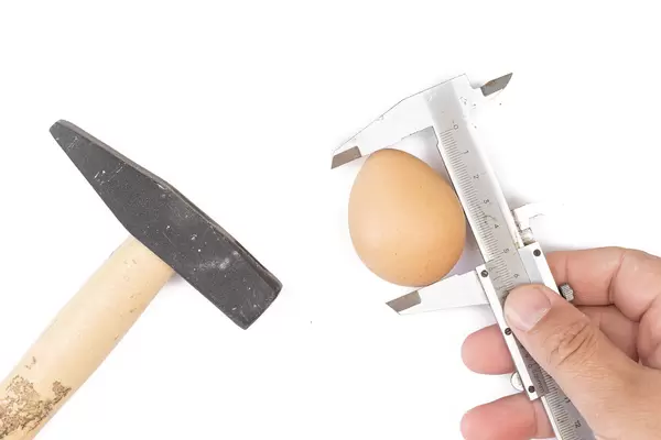 Concept of tools with food and measuring egg with caliper