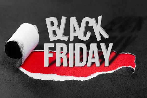 Conceptual background to Black Friday. Black torn paper and the inscription "black friday" on a red background