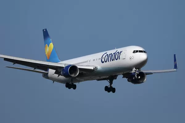Condor plane approaching to landing, blue sky