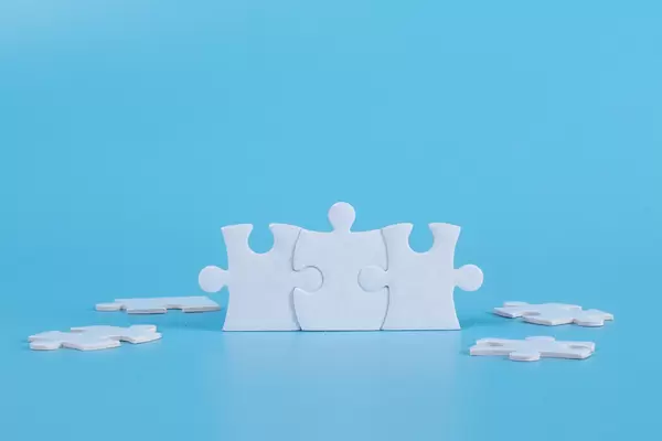 Connected jigsaw puzzle pieces on blue background