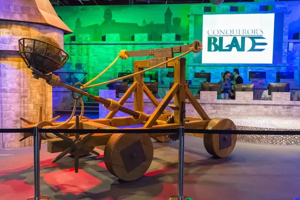 Conqueror's Blade booth with a catapult