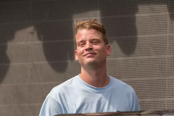 Conro smiles at the festival visitors while playing music in the Rose Garden stage at Tomorrowland