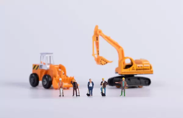 Construction workers with crawler excavator and excavator on white background