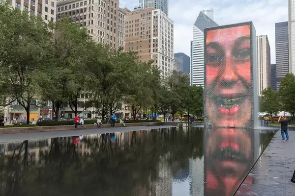 Controversial attraction in Chicago: a human face is reflected on the granite pool of the Crown Fountain at Millennium Park