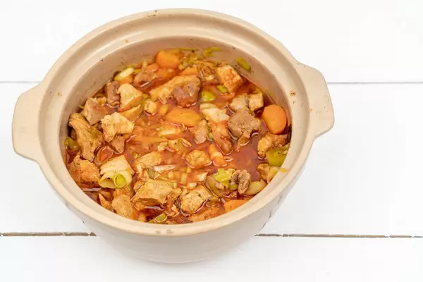 Cooked Beef Stew in the pot above wooden table (Flip 2020)