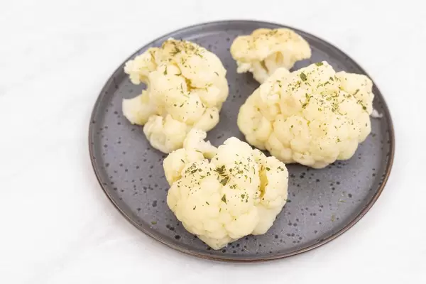 Cooked Cauliflower on the plate with copy space
