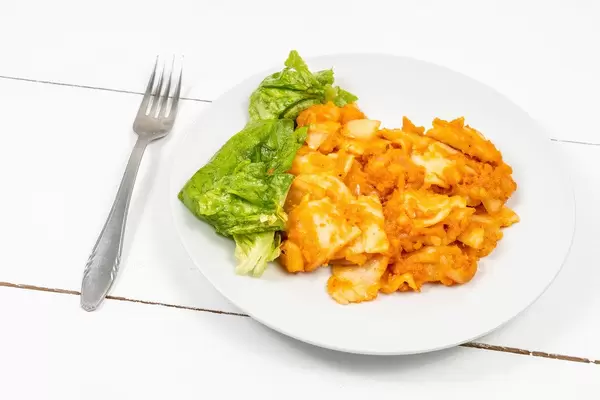 Cooked Dough with Paprika and Onions and Lettuce Salad