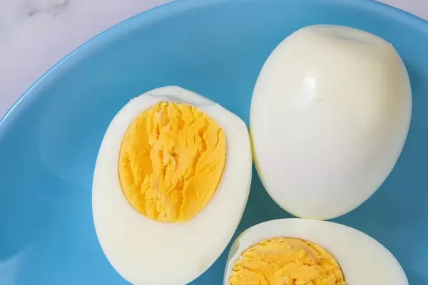 Cooked Eggs served on the blue plate