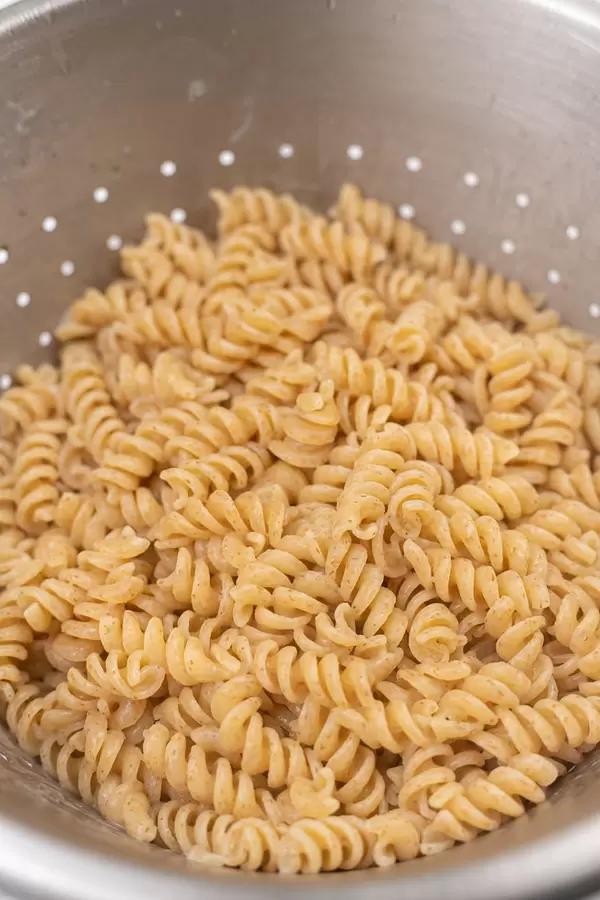 Cooked Macaroni in the metal strainer ready for serving with stew