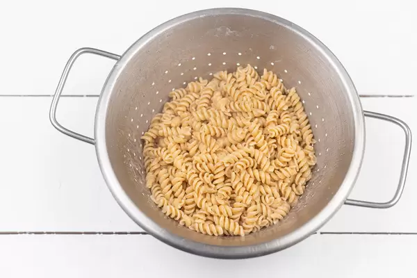Cooked Macaroni in the metal strainer
