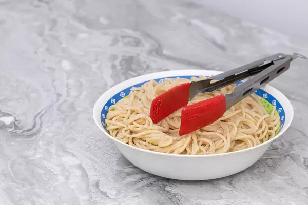 Cooked Spaghetti in the bowl on the grey marble table