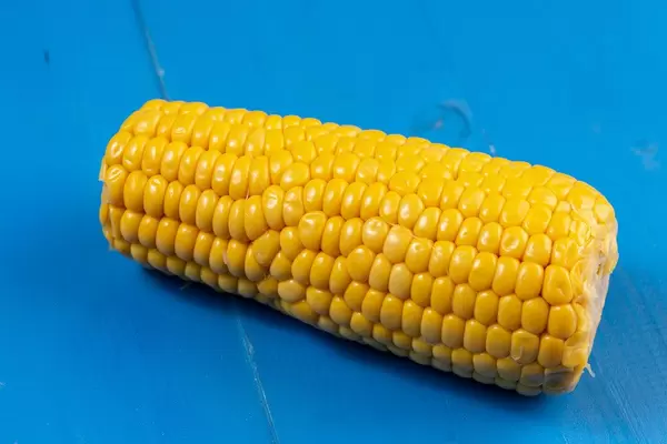 Cooked Young Corn on the blue boards