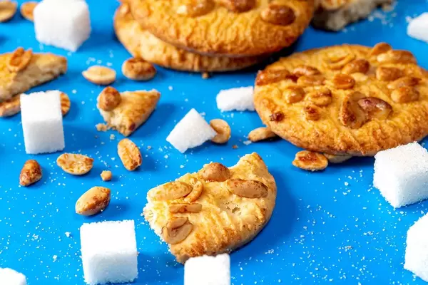 Cookies with peanuts and sugar cubes on a blue background closeup (Flip 2019)