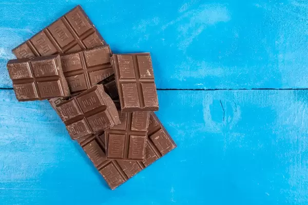 Cooking Chocolate bars on the blue wooden background (Flip 2020)