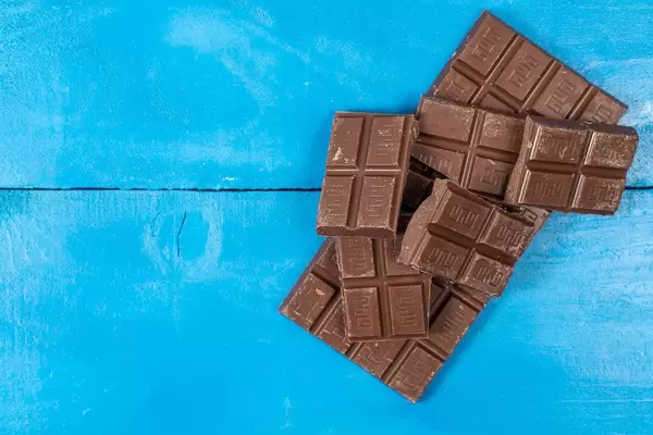 Cooking Chocolate bars on the blue wooden background
