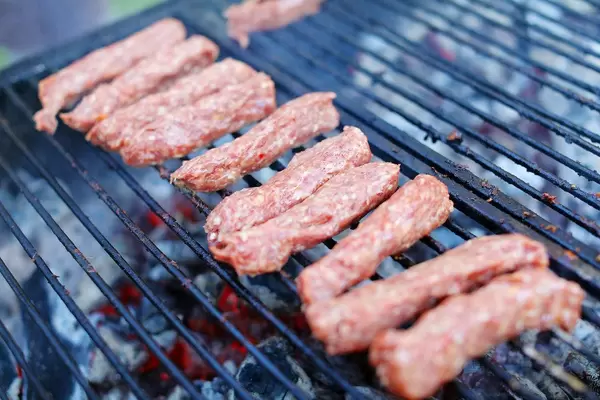 Cooking grilled minced meat rolls in row (Flip 2019)