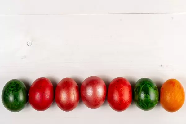 Copy space above wooden background and Colored Easter Eggs