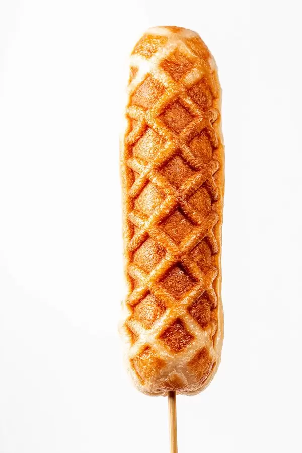 Corn dog on a stick on a white background (Flip 2020)