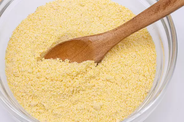 Corn Flour in the bowl with Wooden Spoon