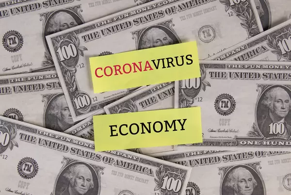 Coronavirus economy text with the US dollars banknotes