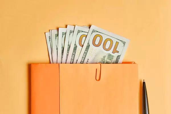 Corruption - a pile of us dollar banknotes in the notepad