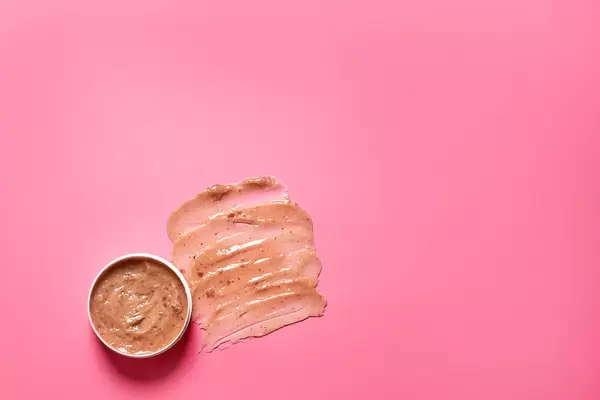 Cosmetic scrub on colorful background