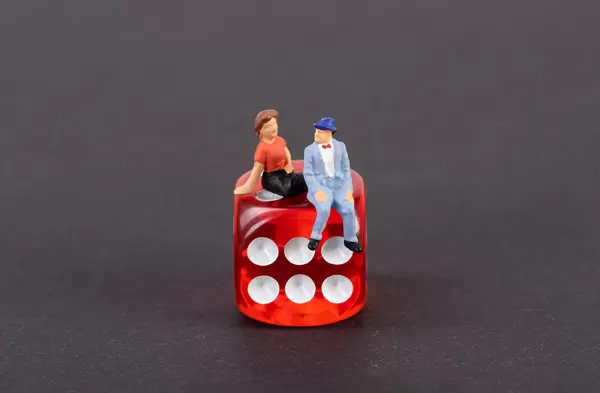 Couple sitting on a dice