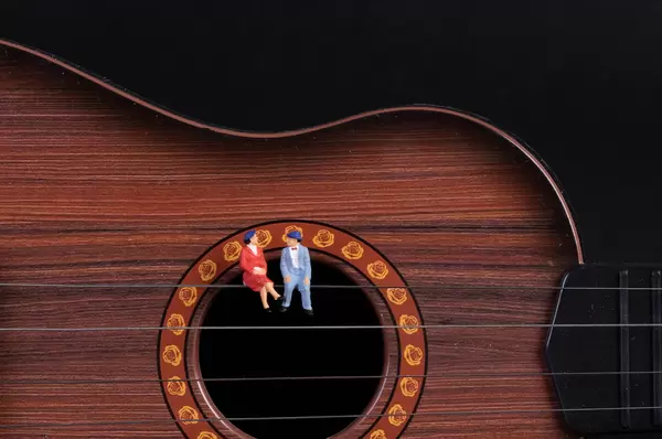 Couple sitting on a guitar