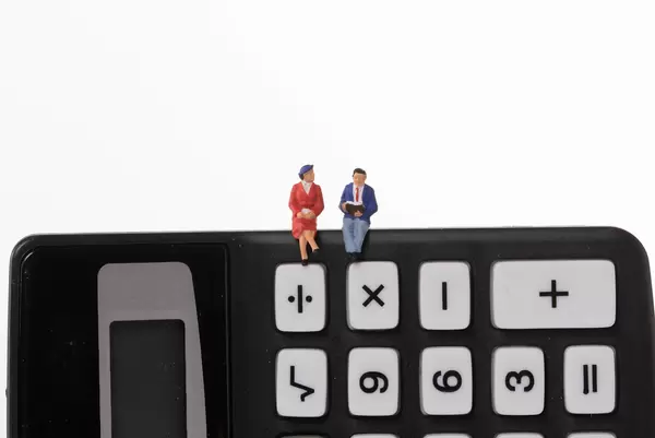 Couple sitting on calculator