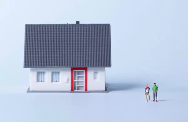 Couple with house on a light blue background