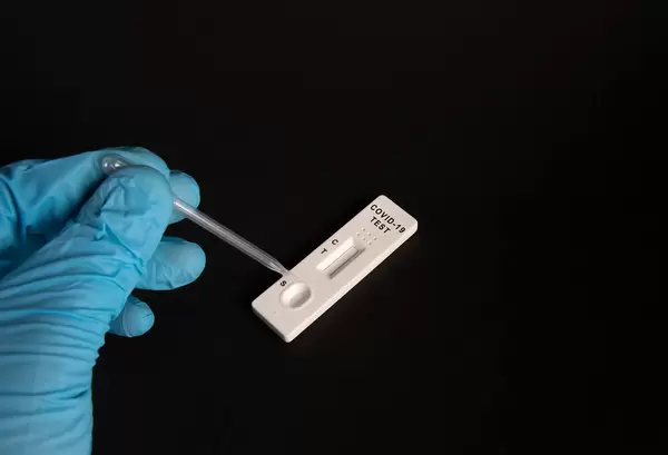 Covid-19 Ag rapid antigen kits seen on a table during dripping swab sample for Coronavirus Covid-19 rapid antigen test