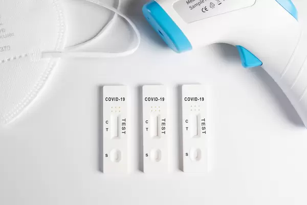 Covid 19 Antigen tests with digital thermometer and face mask