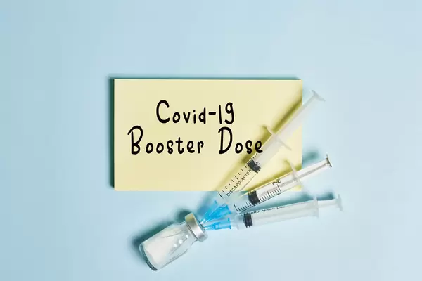 Covid-19 booster shot vaccine with vial and syringes