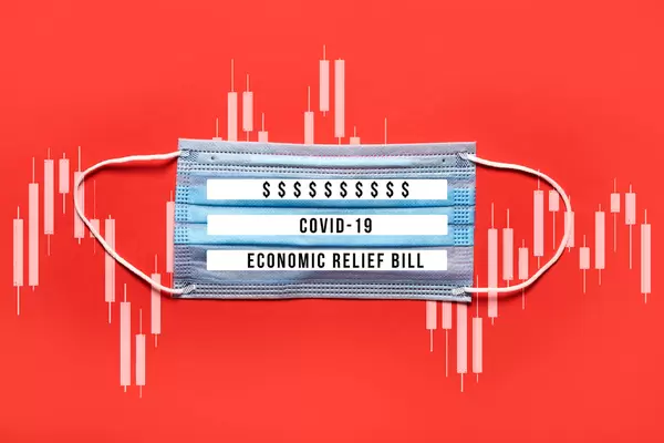 COVID-19 - Economic relief bill written on the medical face mask