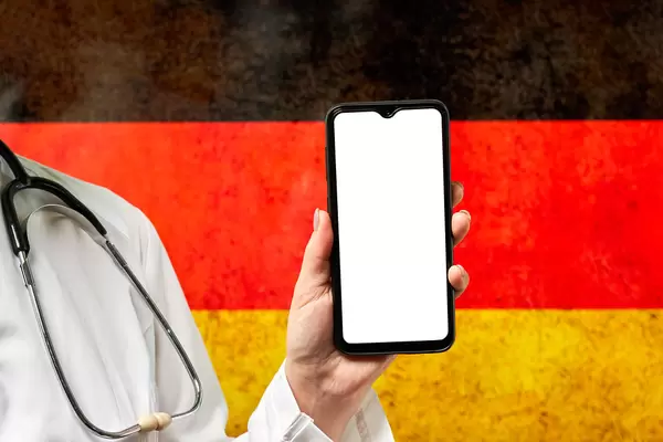 Covid-19 frontline doctor holding a smartphone with a blank screen