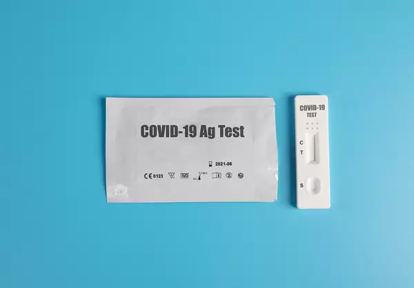 Covid-19 rapid antigen test kit on blue background