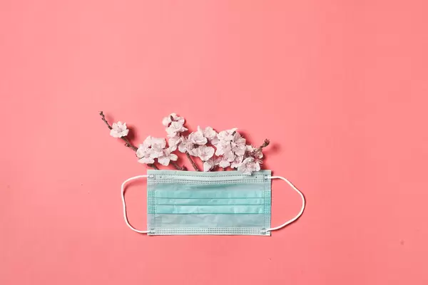 Covid-19 spring lockdown - fresh blossoms and medical face mask