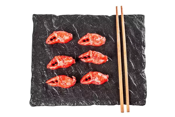 Crab claws on a black stone tray, top view