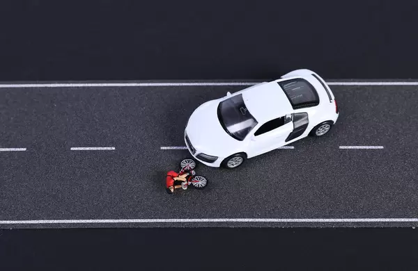 Crash with cyclist and white sports car