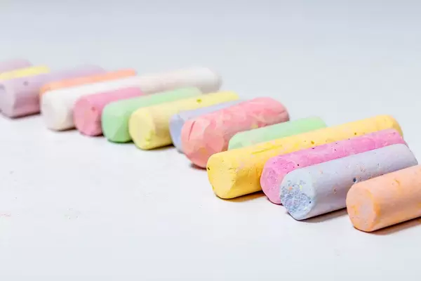 Crayons of different colors on white background (Flip 2019)