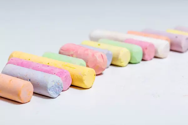 Crayons of different colors on white background