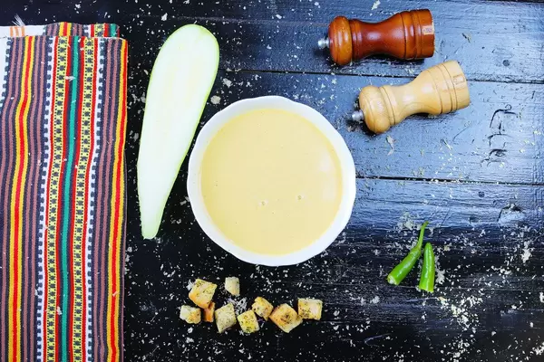 Cream of zucchini soup with croutons, vegan dish, black background. Balkan cuisine (Flip 2019)