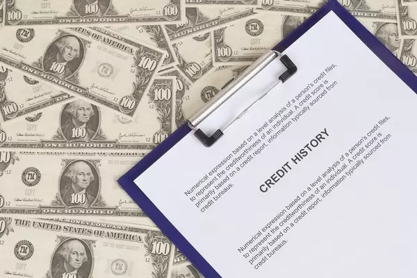 Credit History document with Dollar banknotes
