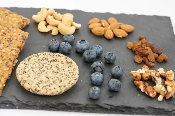 Crispbreads Blueberries Almonds Raisins and other on the stone tray