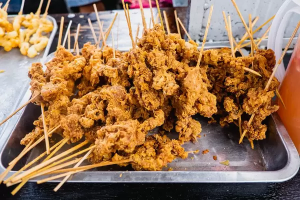 Crispy chicken skin on a stick
