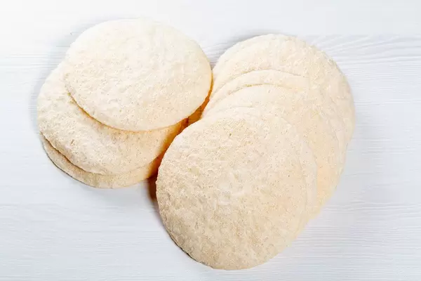 Crispy round rice bread on white background