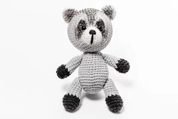 Crochet handmade raccoon toy on a white background (Flip 2019)